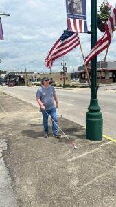 James walking with a white cane