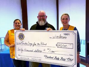 Barry and two Pearland Lady Lions members holding an oversized check