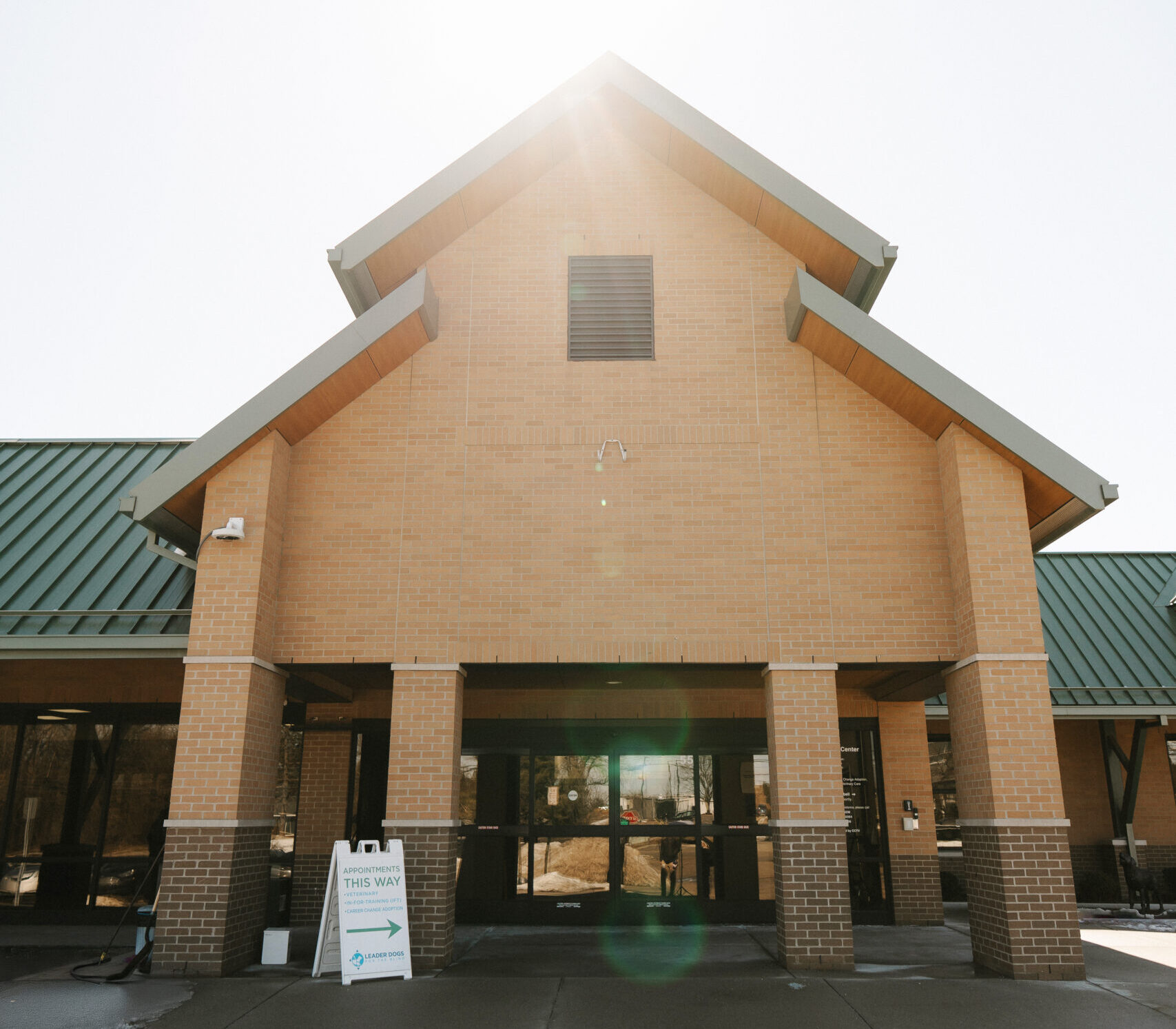 Leader Dogs for the Blind campus entrance with covered walkway and directional signage.