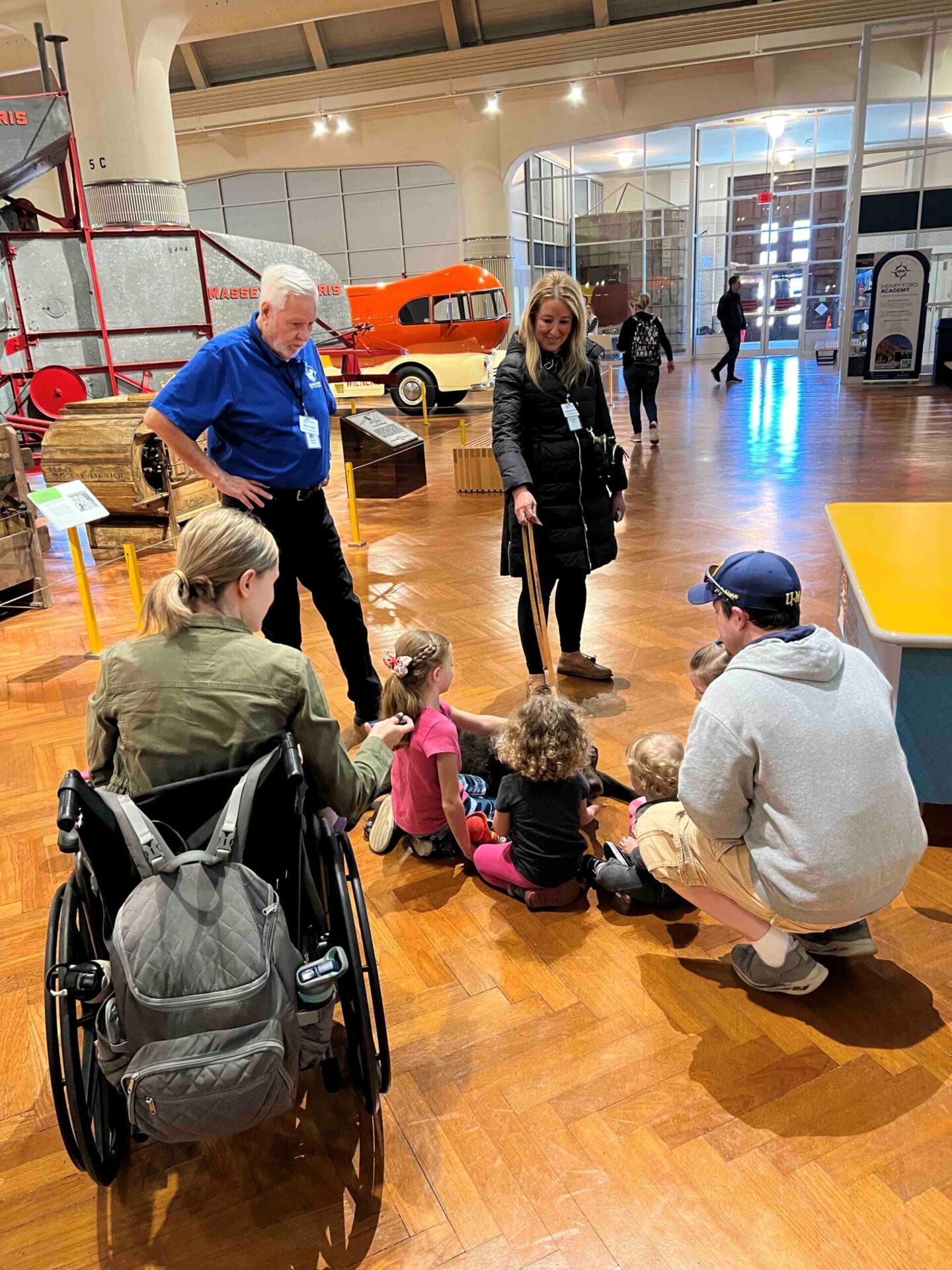 A group of children and adults meet a Leader Dog puppy