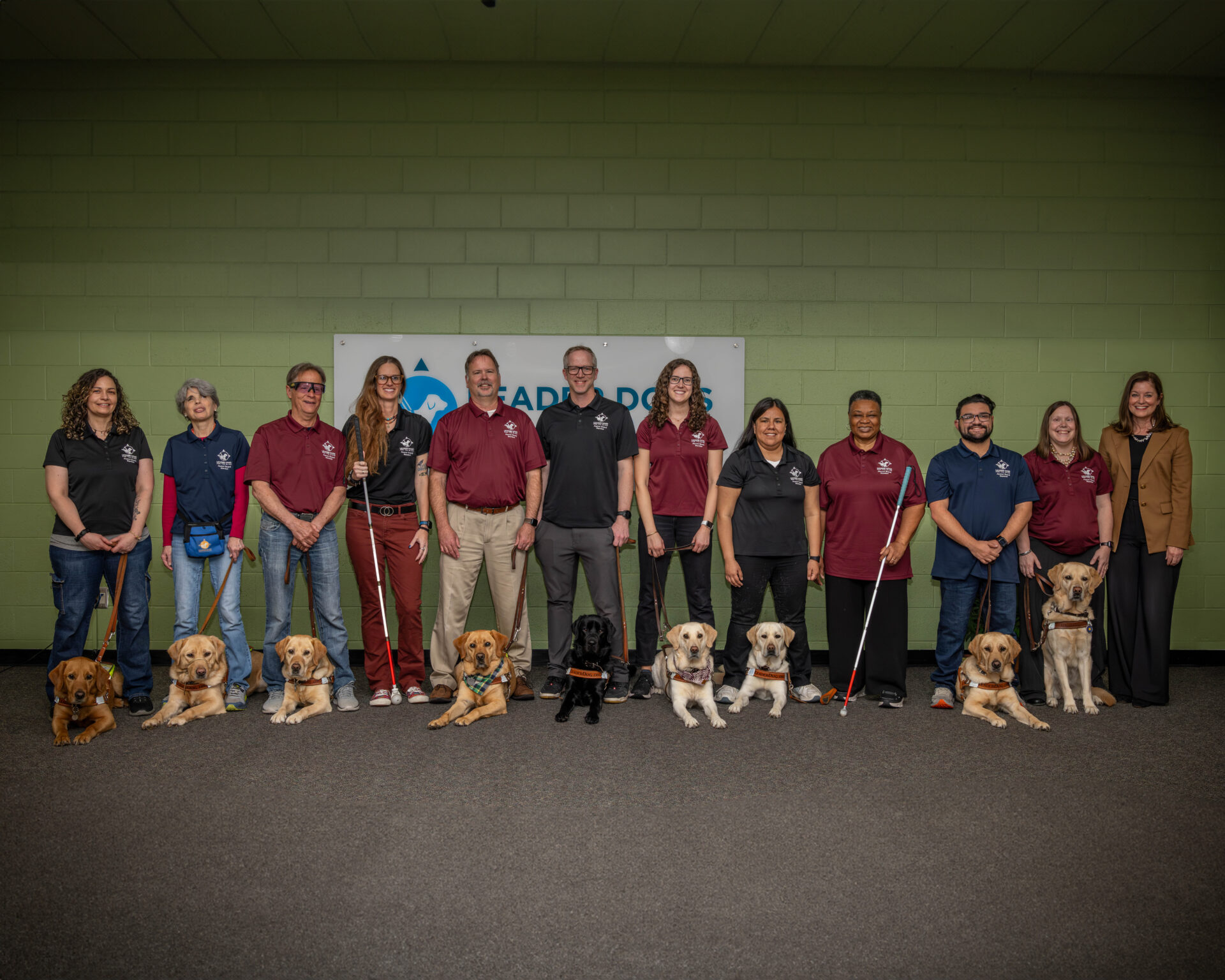 A group shot of all the Alumni Board and the CEO wearing red or navy-blue polos.
