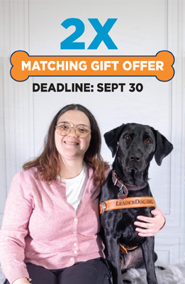 Promotional graphic for a 2X matching gift offer with a September 30 deadline. Below the headline, a person seated beside a black Leader Dog wearing a Leader Dog harness is shown in a portrait-style photograph.