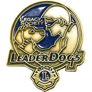 A lapel pin features a male, wearing classes face to face with a dog. The young man holds the face of the dog in his hands. The pin features the Lions International Logo and the words "Leader Dogs" and "Legacy Society"